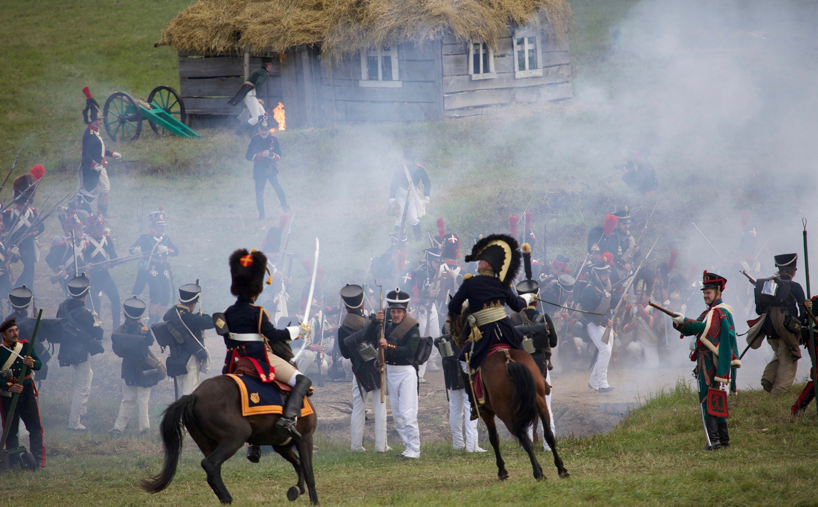 A battle between soldiers on horseback wearing Napoleanic war uniforms