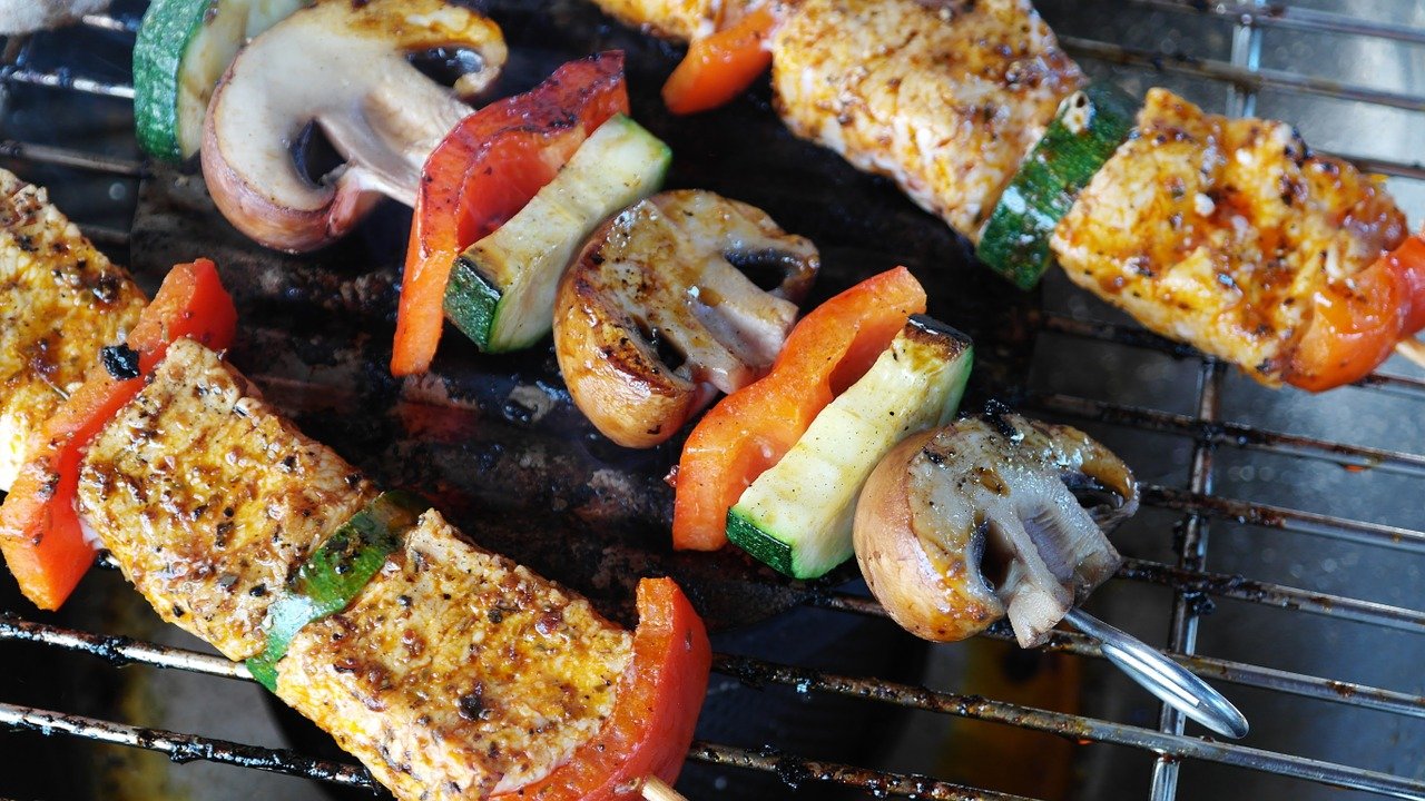 Skewers with meat and vegetables on a barbecue